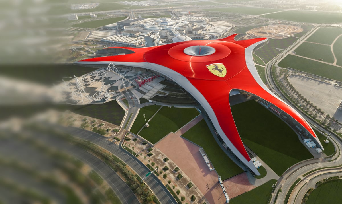 Aerial view of Ferrari World's sweeping red roof and prancing horse on Yas Island