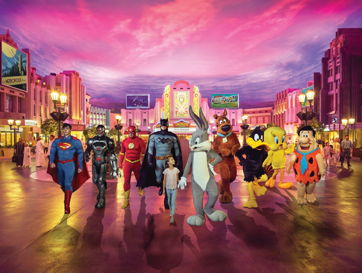 Superman, Batman, Bugs Bunny and other characters walking down a street under a pink sky